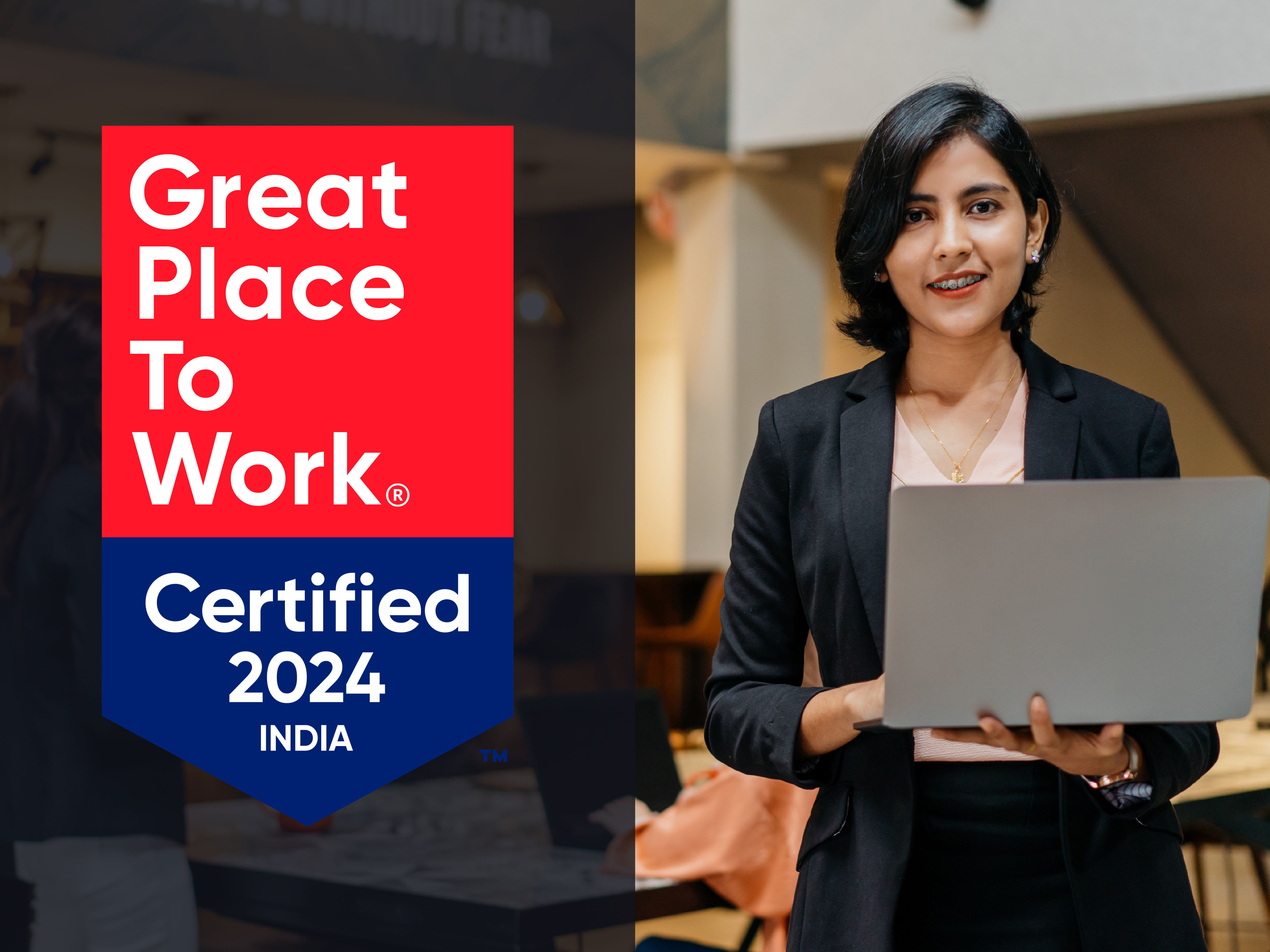 A lady with a laptop and on top of that there is a Great Place To Work Certification Badge