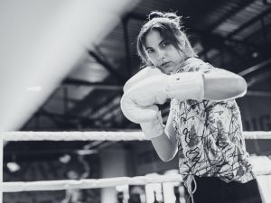 Young woman boxer training at the gym