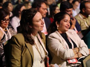 Two women with the audience for the For All Summit Mumbai 2025